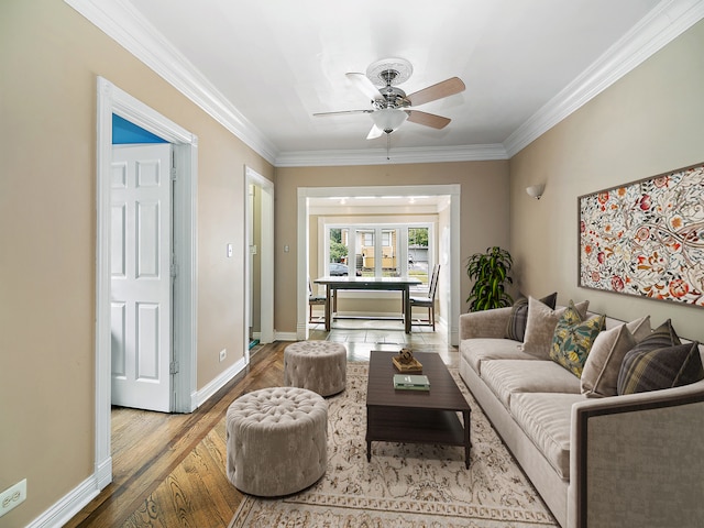 living room featuring crown molding, ceiling fan, and wood-type flooring