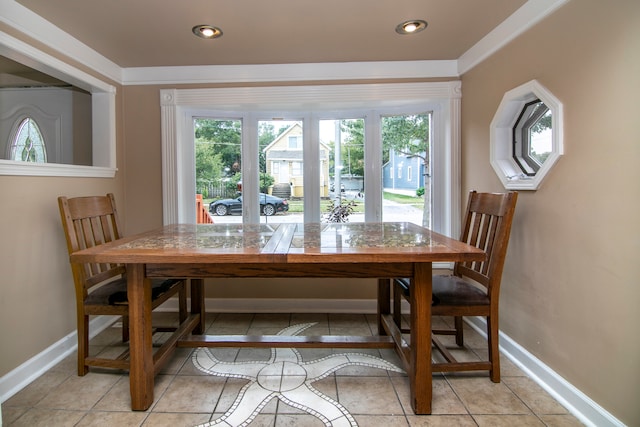 dining room with light tile patterned floors and a healthy amount of sunlight