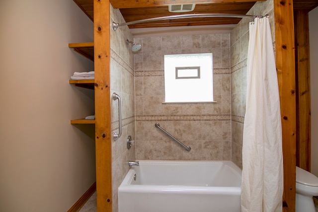 bathroom featuring shower / bath combination with curtain and toilet