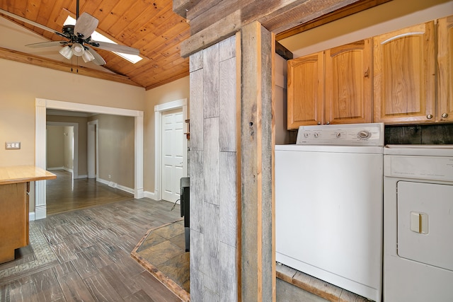 laundry room with cabinets, ceiling fan, wooden ceiling, washer and dryer, and dark hardwood / wood-style floors