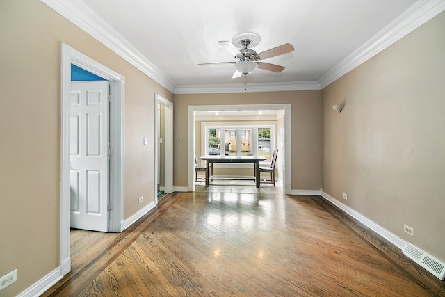 hallway with ornamental molding, french doors, and wood-type flooring