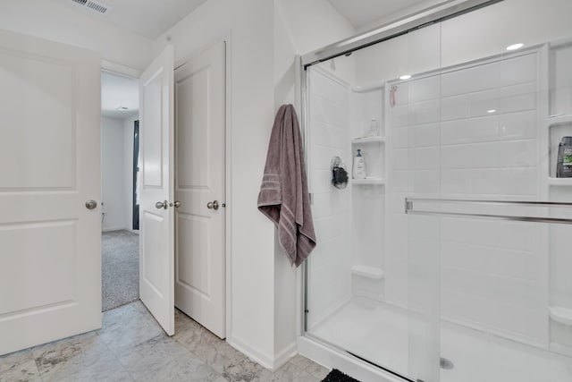 bathroom featuring a shower with shower door