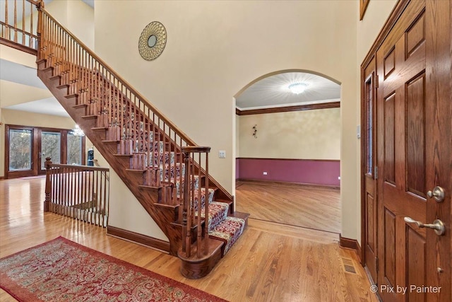 foyer featuring light hardwood / wood-style floors and ornamental molding