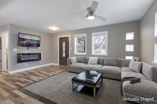 living room featuring wood-type flooring and ceiling fan