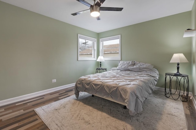 bedroom with wood finished floors, baseboards, and a ceiling fan