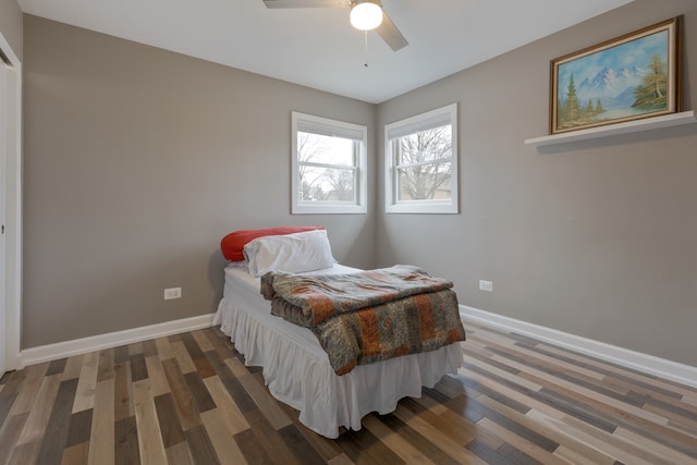 bedroom with ceiling fan and dark hardwood / wood-style floors