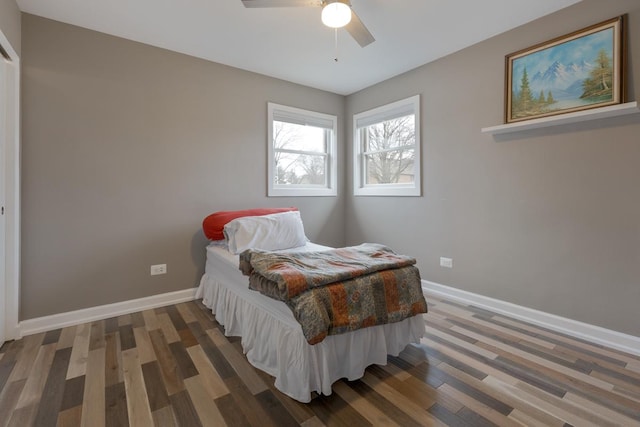 bedroom with wood finished floors, baseboards, and a ceiling fan