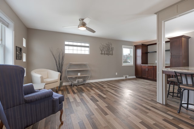 sitting room featuring ceiling fan and dark hardwood / wood-style floors