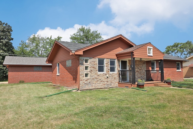 rear view of house with a yard