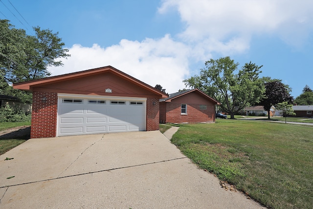 ranch-style house with a garage and a front lawn