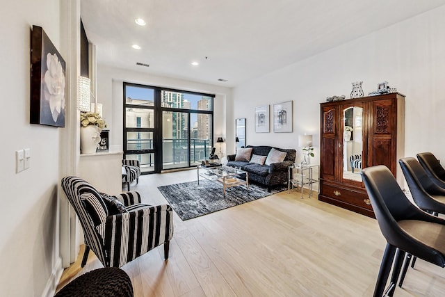 living room with light hardwood / wood-style flooring