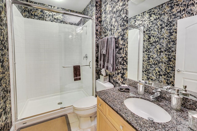 bathroom featuring vanity, a shower with shower door, toilet, and tile patterned flooring