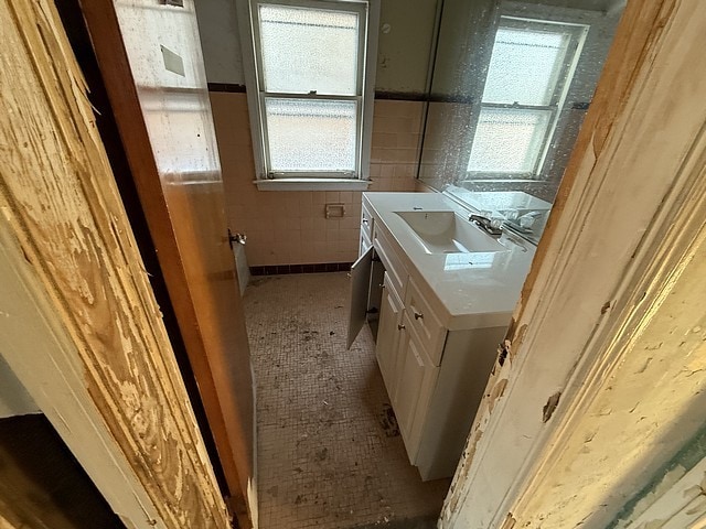 bathroom featuring vanity, tile patterned flooring, and tile walls