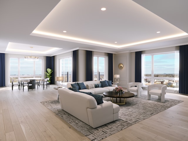 living room with a raised ceiling, light wood-type flooring, and a wealth of natural light