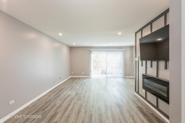 unfurnished living room with hardwood / wood-style floors