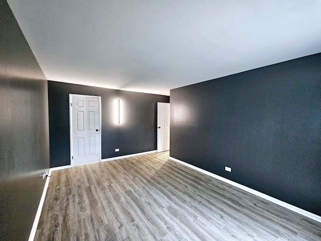 empty room with hardwood / wood-style flooring