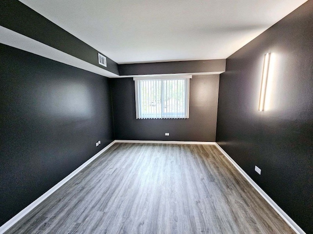 empty room with hardwood / wood-style flooring