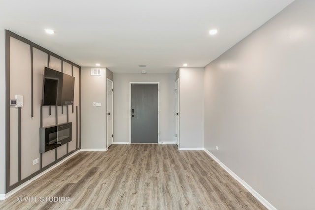 unfurnished living room with light wood-type flooring