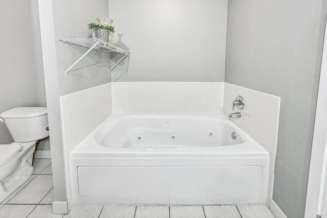 bathroom featuring a bathing tub, tile patterned floors, and toilet