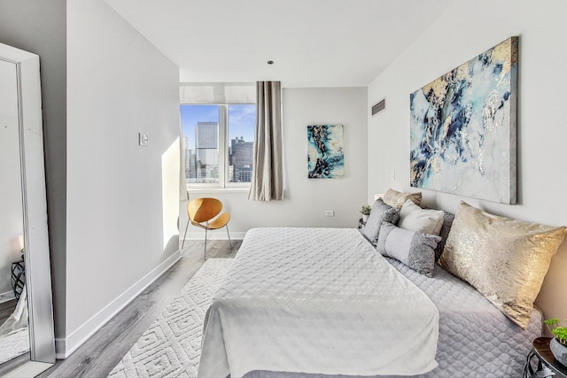 bedroom with hardwood / wood-style flooring