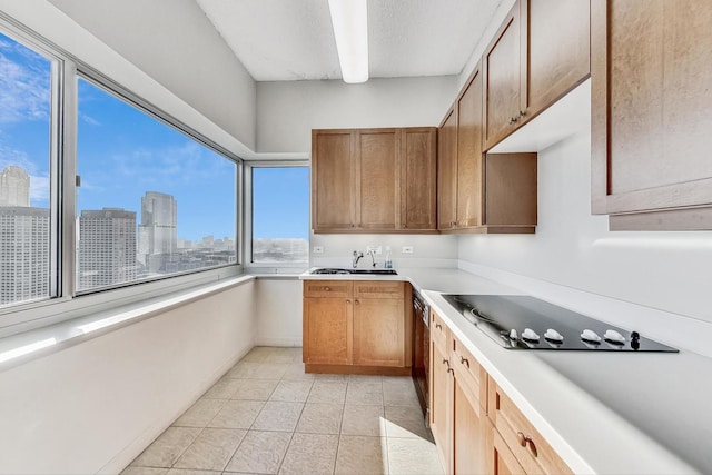 kitchen with light tile patterned floors, black electric cooktop, and sink