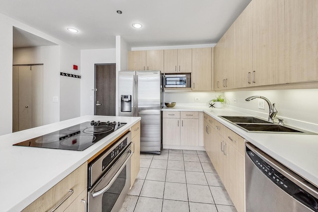 kitchen featuring light brown cabinetry, light tile patterned floors, stainless steel appliances, and sink