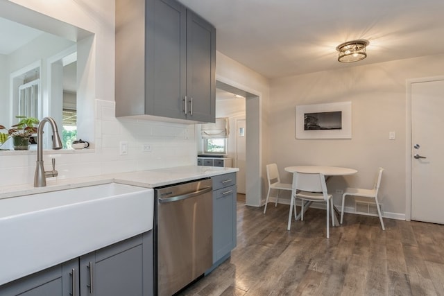 kitchen featuring dark wood-type flooring, a healthy amount of sunlight, and stainless steel dishwasher