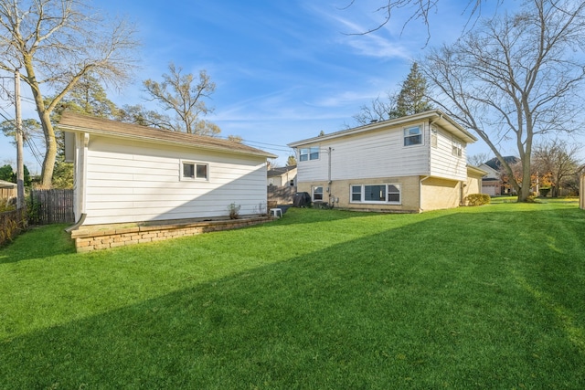 back of house featuring a lawn