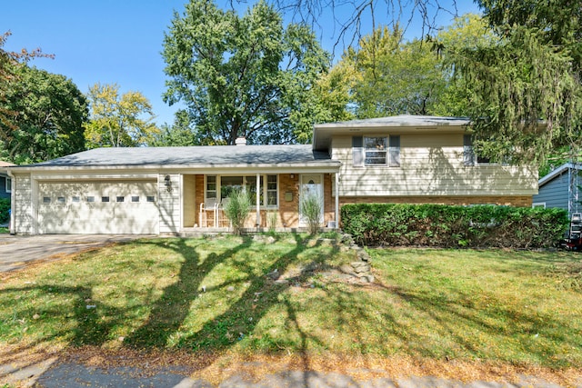 split level home featuring a front yard, a porch, and a garage