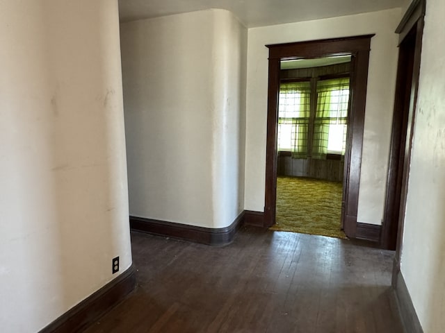 hallway with dark wood-type flooring