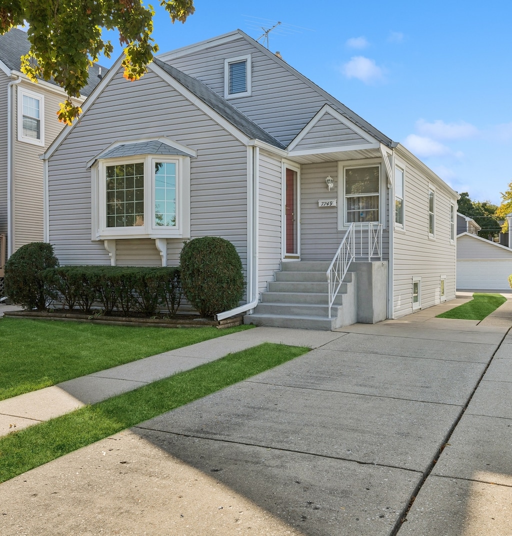 view of front of house featuring a garage and a front lawn