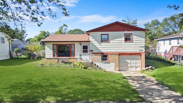 view of front of house featuring a garage and a front lawn