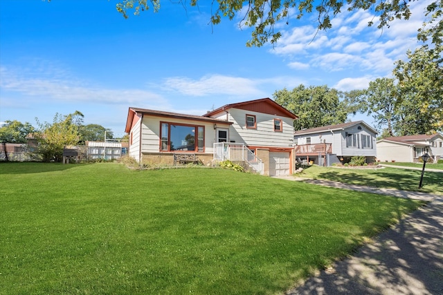 rear view of house with a garage and a yard