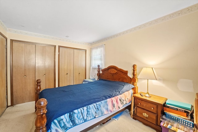 carpeted bedroom featuring two closets