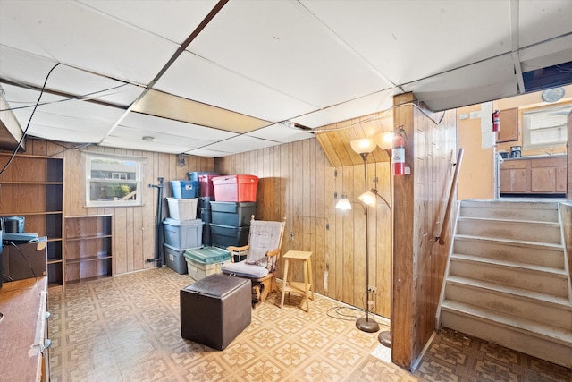 basement featuring wood walls