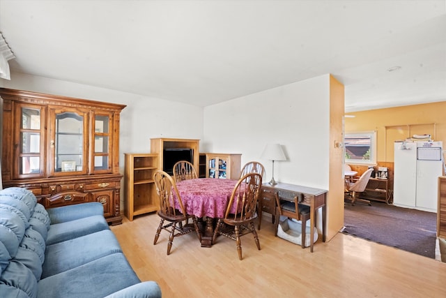 dining space with light hardwood / wood-style flooring