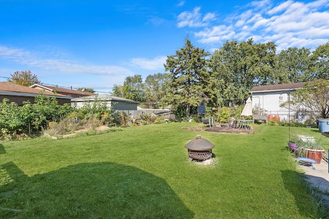 view of yard featuring an outdoor fire pit