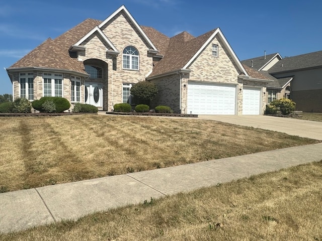 view of front facade with a front yard and a garage