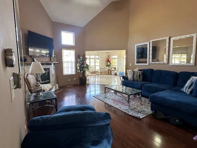 living room with high vaulted ceiling and dark hardwood / wood-style flooring