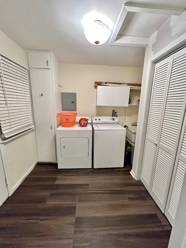 laundry room with dark wood-type flooring, washer and dryer, and electric panel