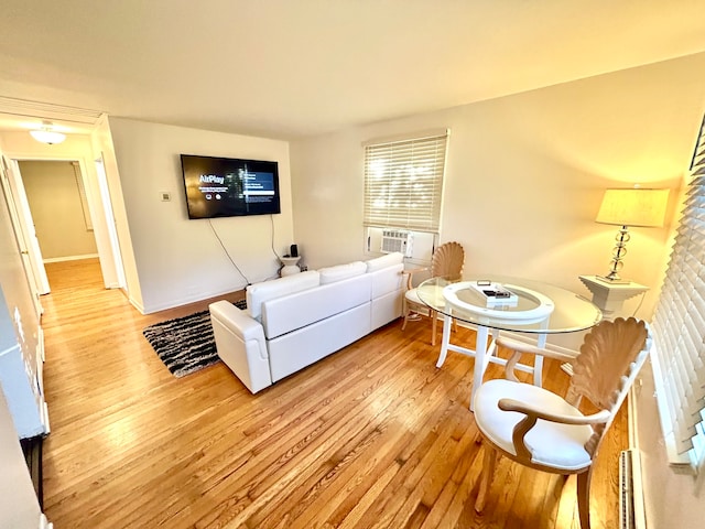 living room featuring cooling unit and light hardwood / wood-style floors