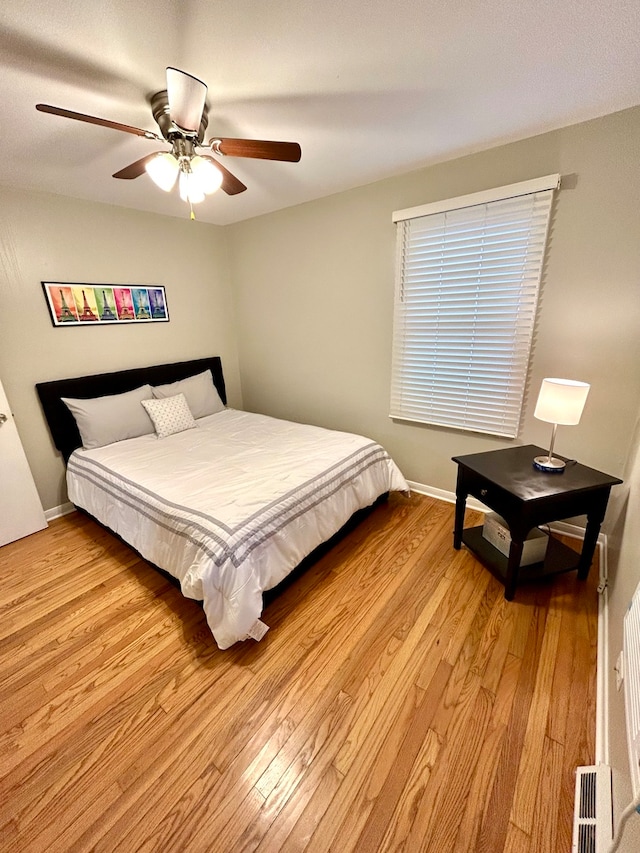 bedroom featuring light wood-type flooring and ceiling fan