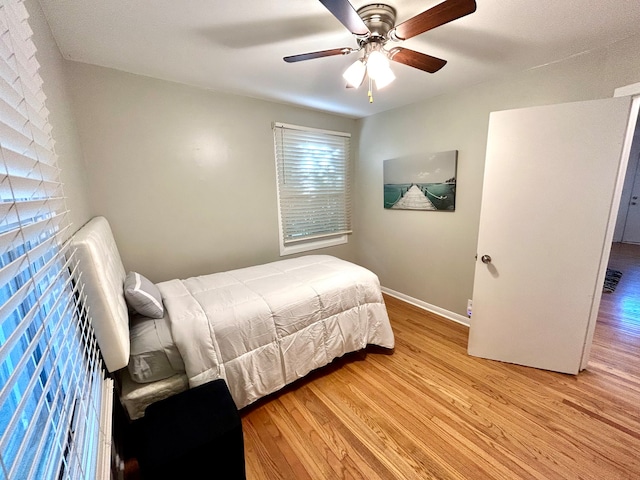 bedroom with ceiling fan and light wood-type flooring