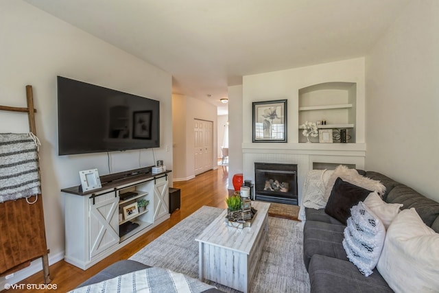 living room featuring hardwood / wood-style flooring and built in features