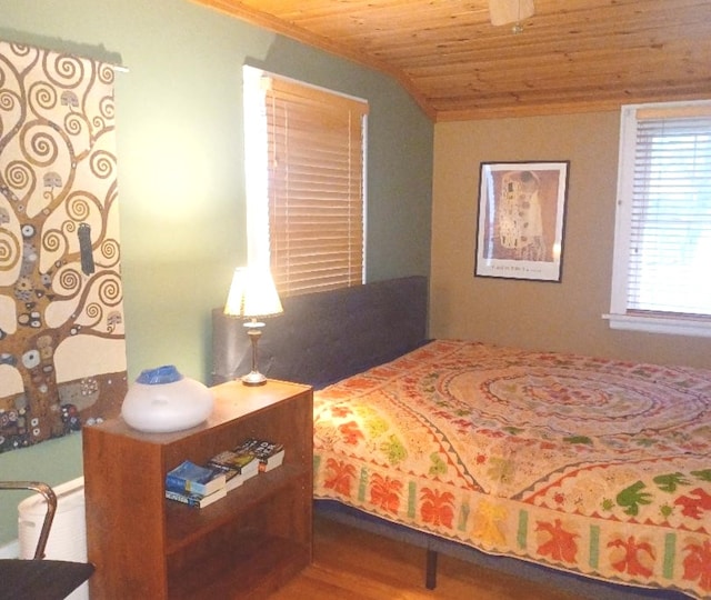 bedroom with wooden ceiling, vaulted ceiling, and wood-type flooring