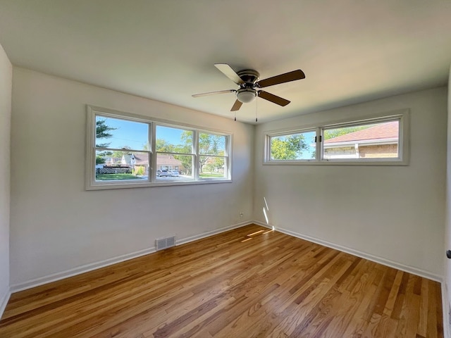 empty room featuring light wood-type flooring and ceiling fan