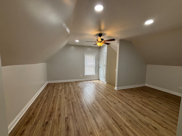 additional living space featuring vaulted ceiling, hardwood / wood-style floors, and ceiling fan