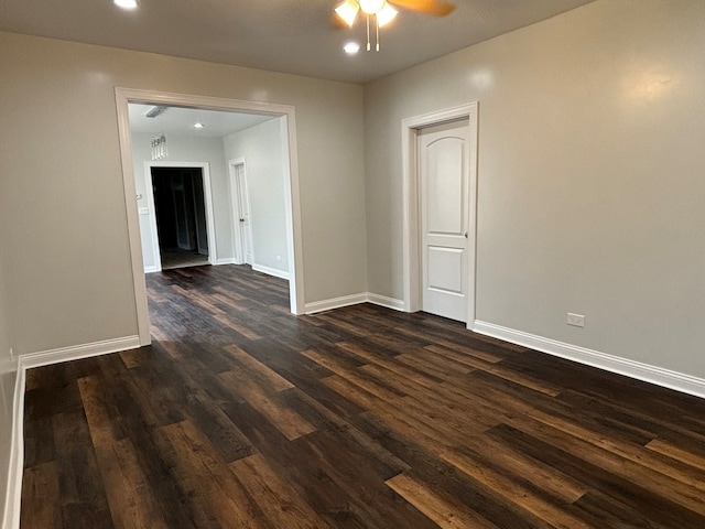 spare room with ceiling fan and dark wood-type flooring