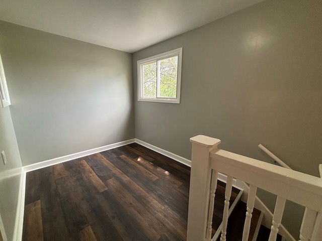 spare room with dark wood-type flooring