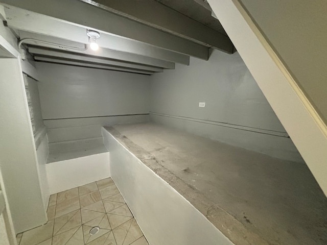 basement with light tile patterned flooring